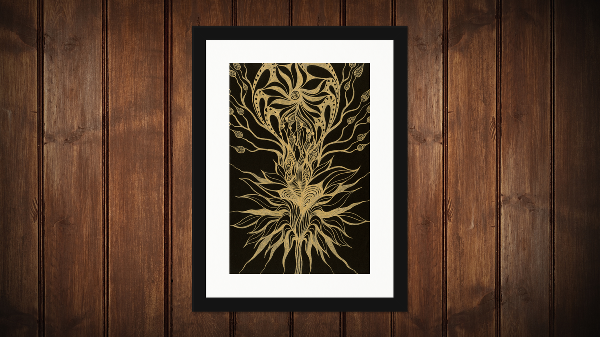 A framed art print featuring a detailed gold tree of life design on a black background, set against a dark brown wood-paneled wall.